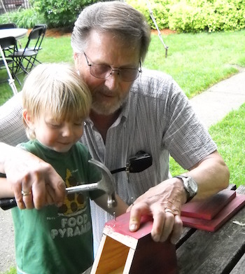 Shawnelle's son and dad working on a birdhouse.