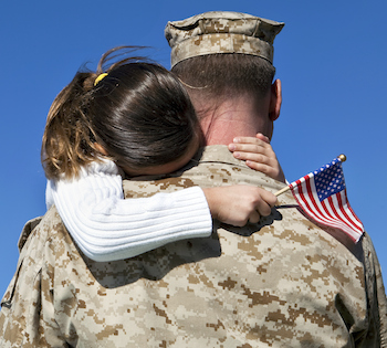 A soldier hugs his daughter. Photo by videodet for Thinkstock, Getty Images.