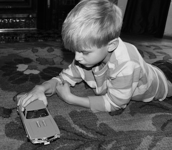 Shawnelle's youngest son, Isaiah, plays with his toy car.