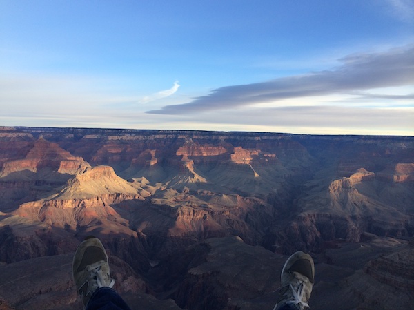 Adam's feet dangle over the Grand Canyon.