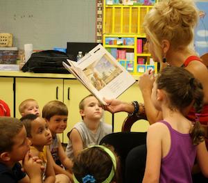 Michelle reading from one of her children's books to a group of young readers.