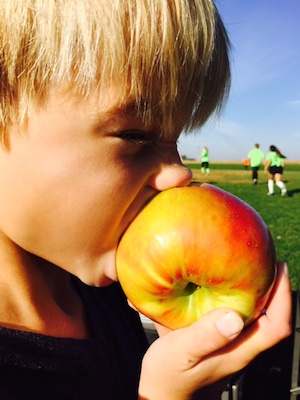 Isaiah eating an apple on a beautiful fall afternoon
