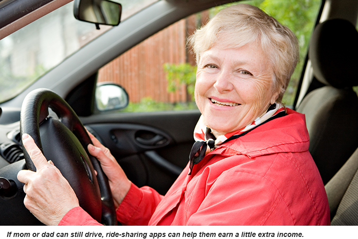 A smiling senior woman behind the wheel of her car